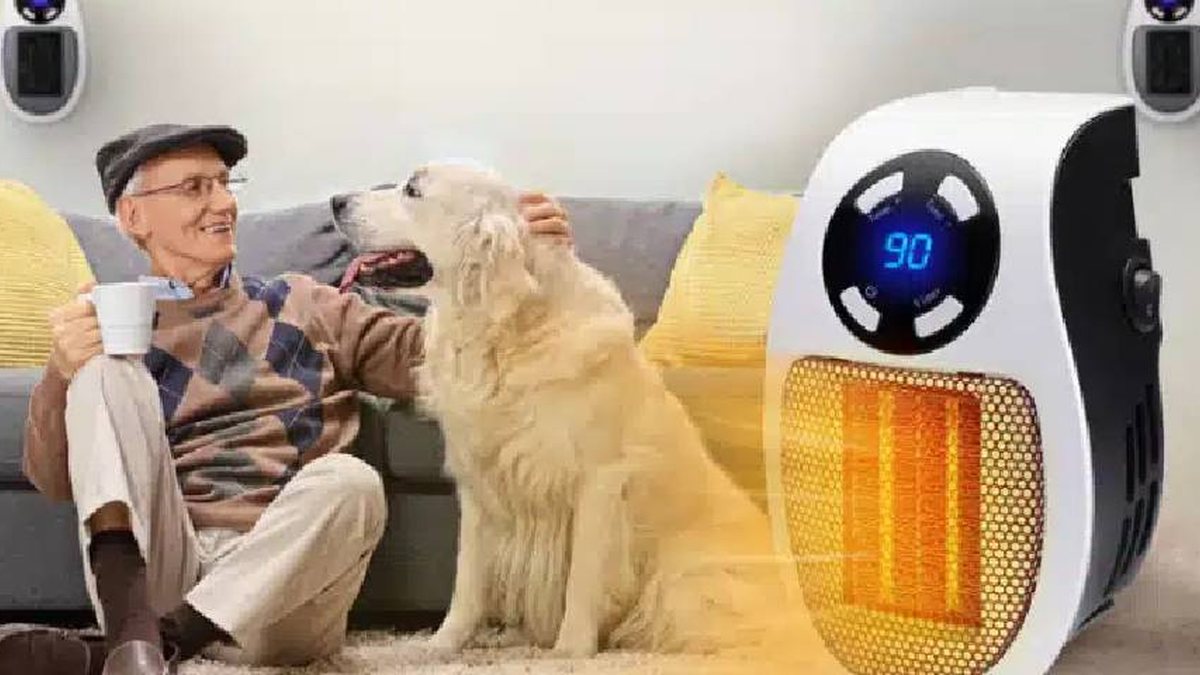 A man and his dog relaxing beside a small space heater
