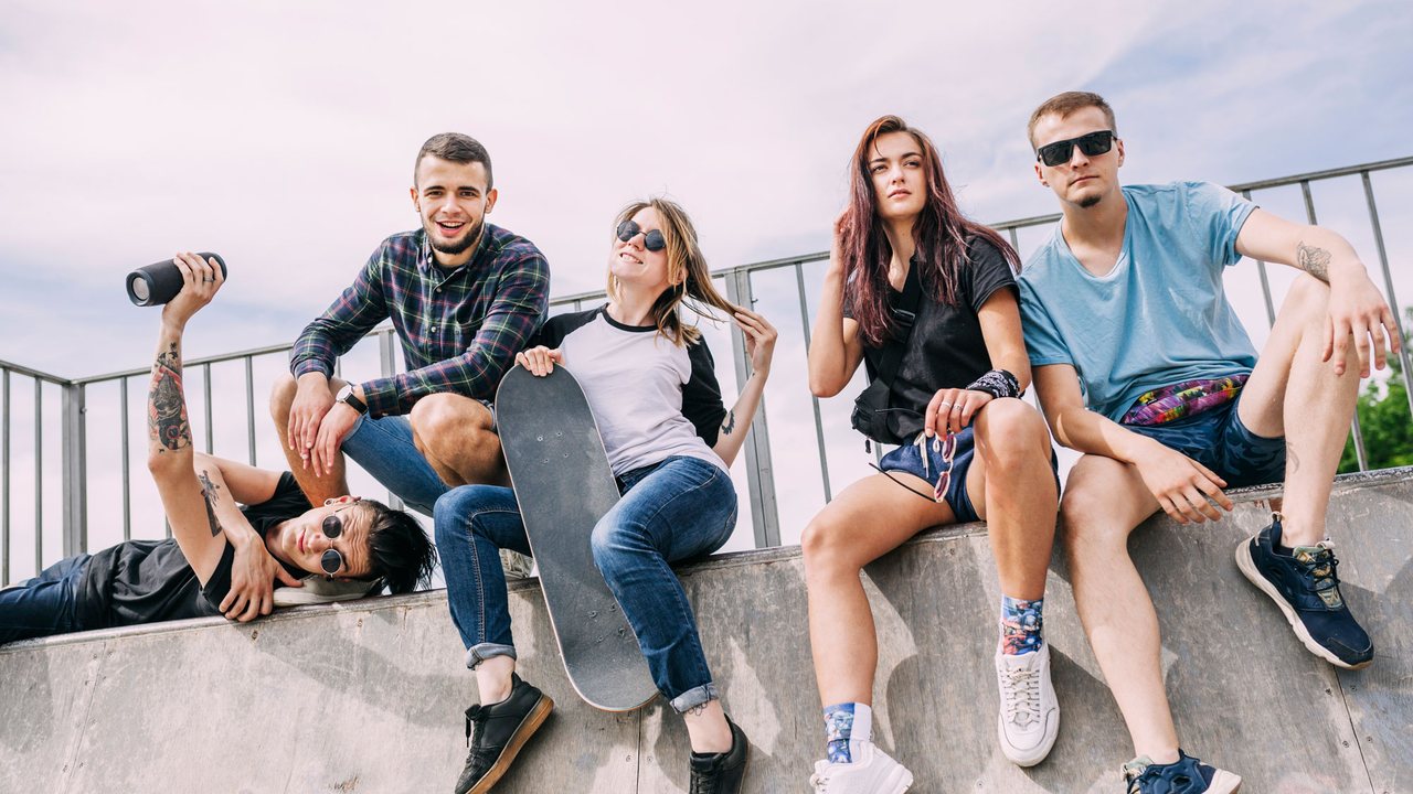 Four friends hanging out on a rooftop